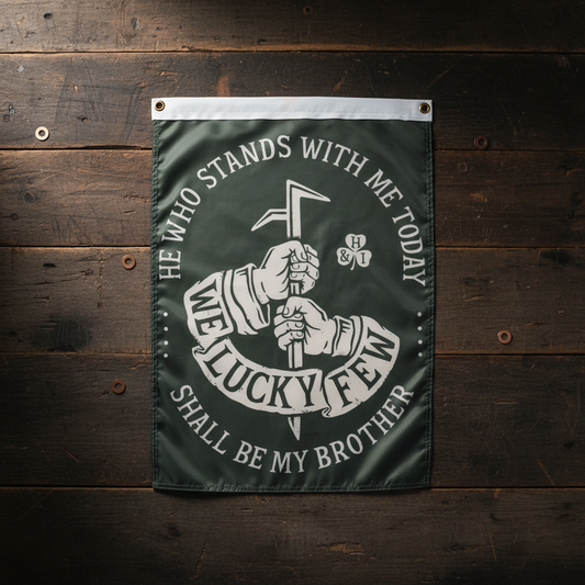 Green flag with white text and graphic on a wooden background