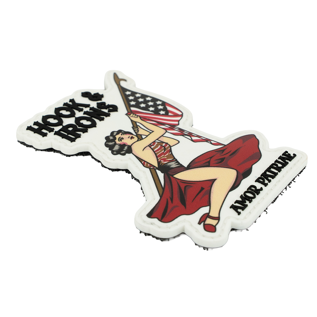 Decorative PVC Patch with a woman holding an American flag, 'Hook & Ladder' text, and 'Amor Paterno' branding.