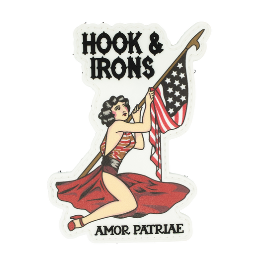 PVC Patch with a woman holding an American flag and spear, text 'Hook & Irons' and 'Amor Patriae', on a white background.