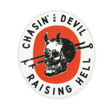 Circular sticker with a skull and crossed hooks design, text 'Chasin' the Devil Raising Hell', on a white background.
