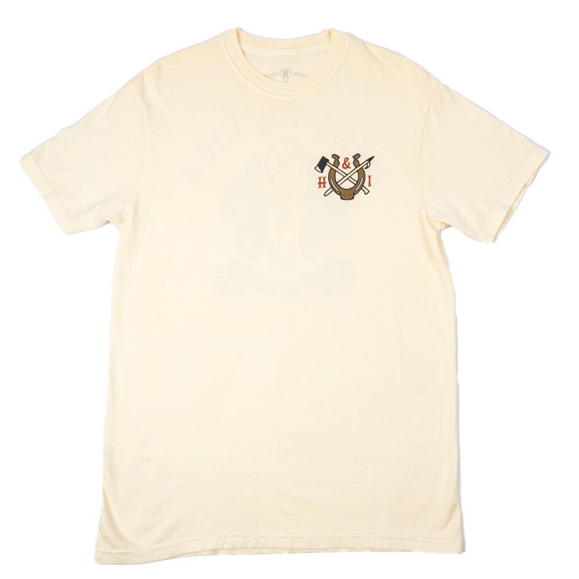 A cream-colored short-sleeve t-shirt with a small screen printed crest on the left chest, displayed flat against a solid white background.
