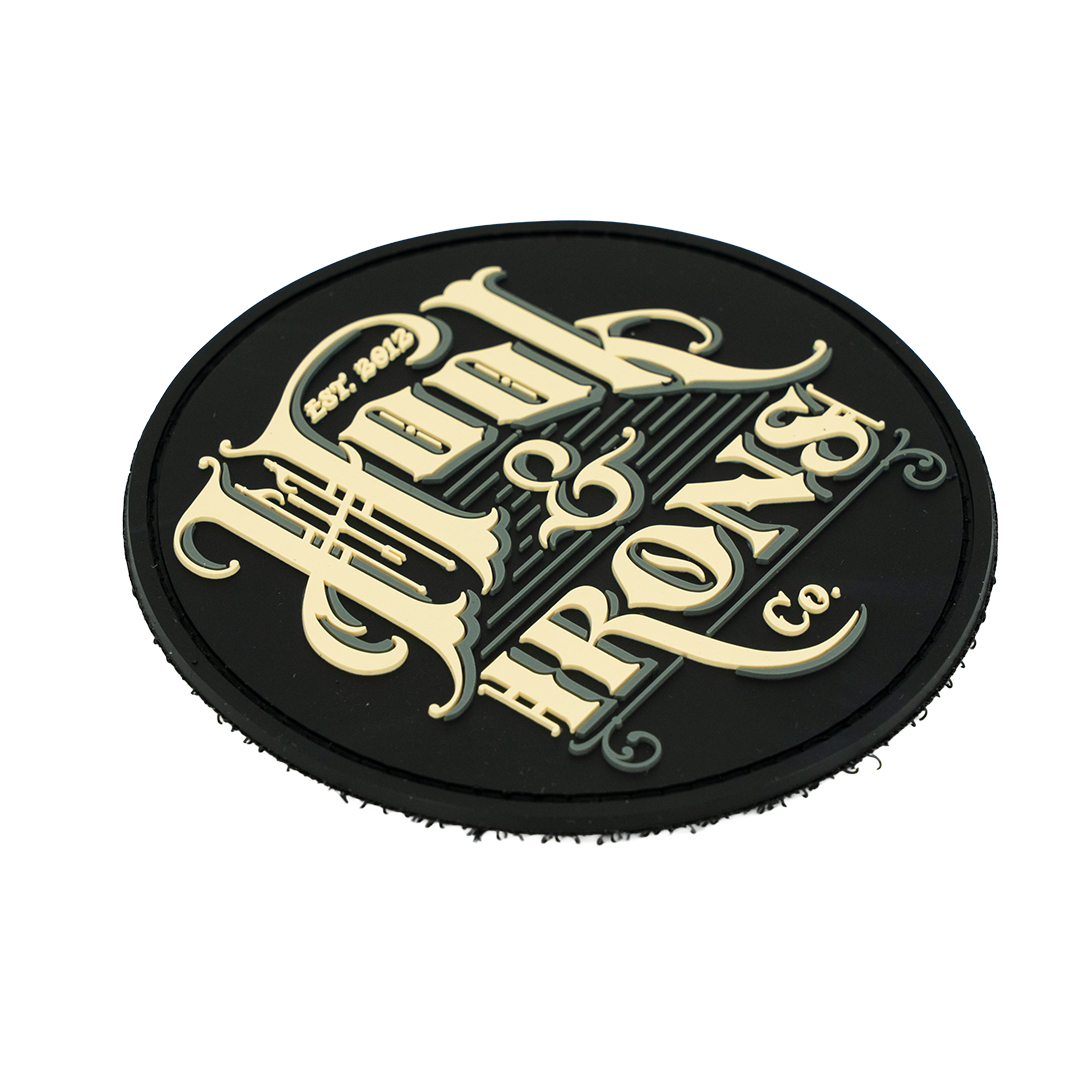 Black patch with creme text on a white background