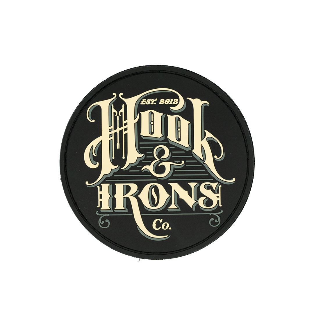 Round black patch with 'Hook & Irons Co.' text in gold on a white background