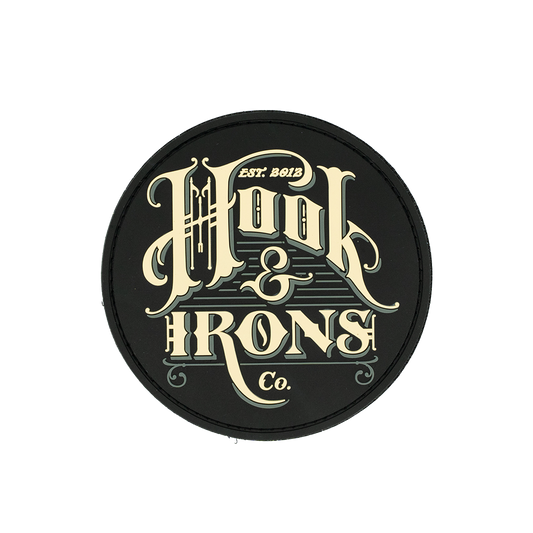 Round black patch with 'Hook & Irons Co.' text in gold on a white background