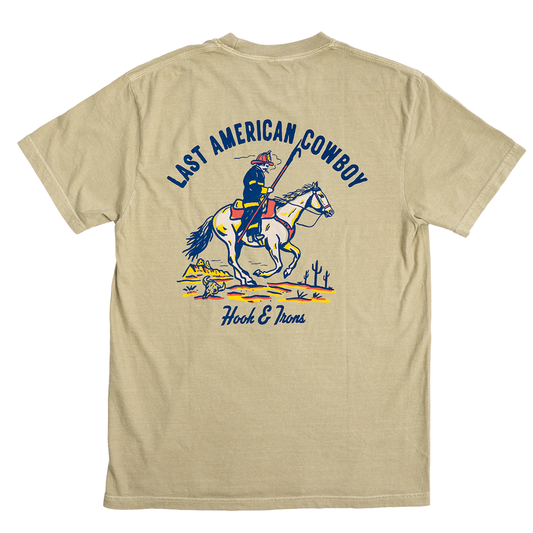 Khaki t-shirt with 'Last American Cowboy' graphic on a white background