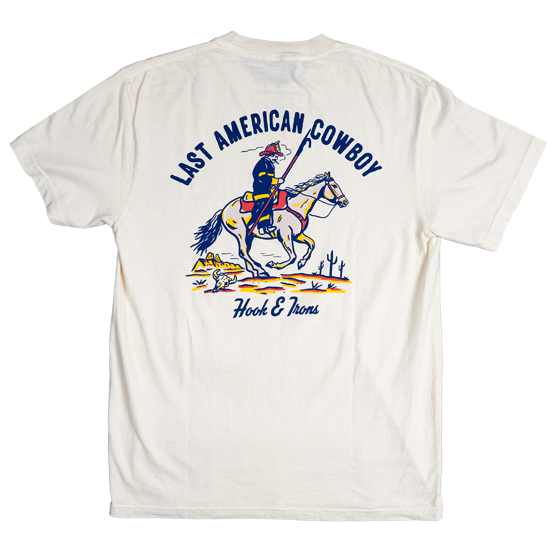 White t-shirt with a graphic of a cowboy on a horse and text 'Last American Cowboy' and 'Hook & Alberts'.