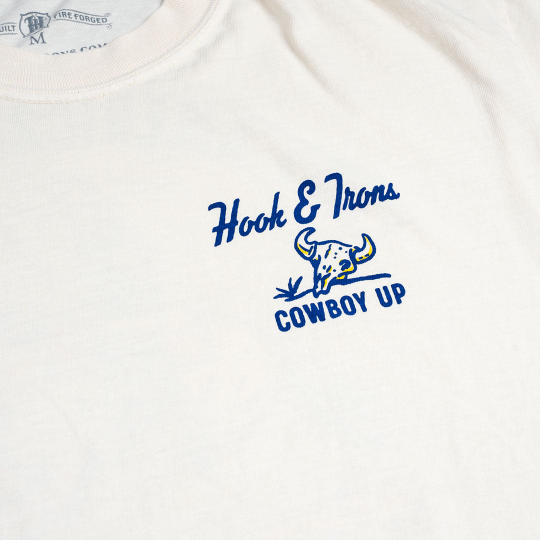 White shirt with blue 'Hook & Irons Cowboy Up' logo on a white background